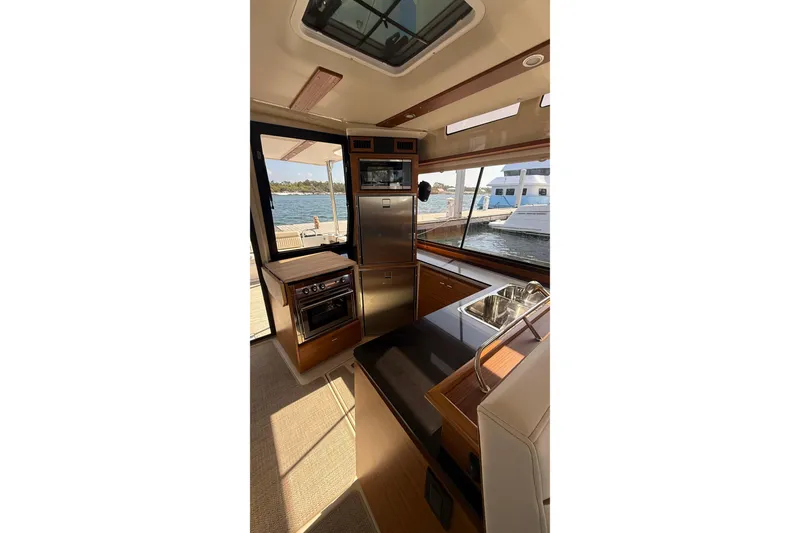 Slide: The Image of Interior of 2026 Ranger Tugs R-43 CB yacht with modern kitchen and waterfront view. - 17