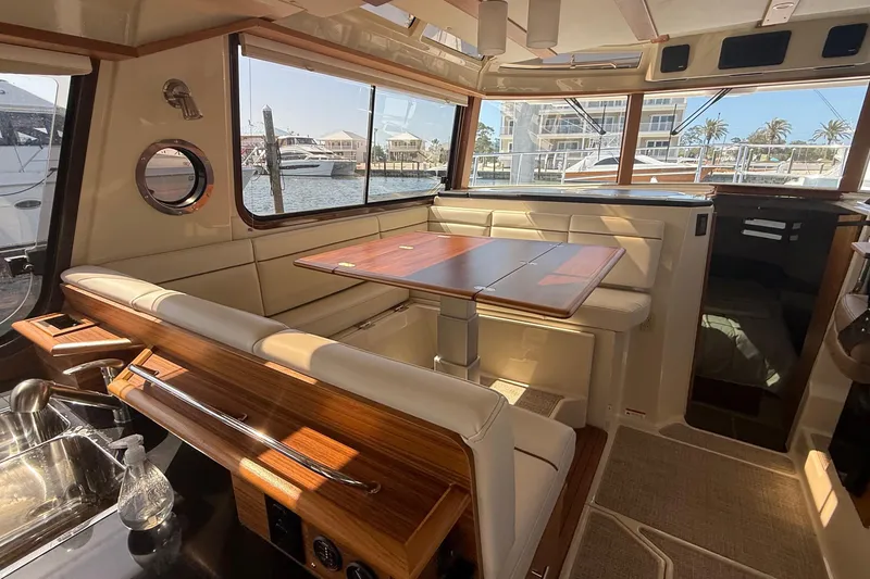 Slide: The Image of Interior of 2026 Ranger Tugs R-43 CB yacht with elegant seating and dining area. - 18