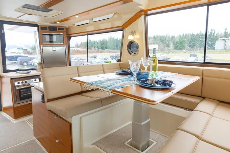 Slide: The Image of Luxurious interior of 2025 Ranger Tugs 43 Command Bridge with elegant dining area. - 26