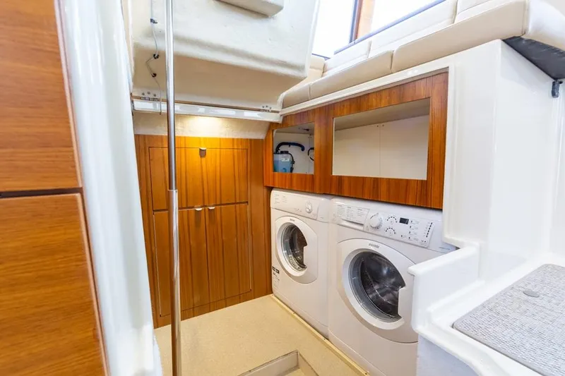 Slide: The Image of Laundry area in 2025 Ranger Tugs 43 Command Bridge yacht with washer and dryer. - 36