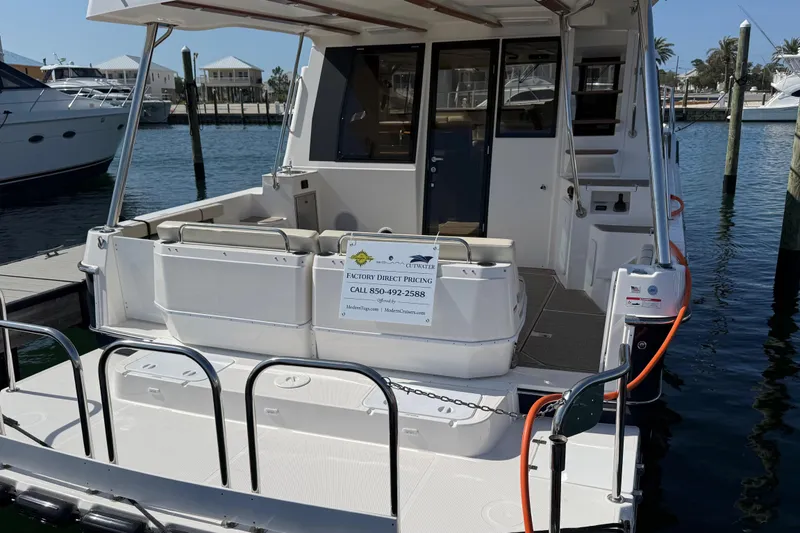 Slide: The Image of 2026 Ranger Tugs R-43 CB yacht docked, showcasing spacious rear deck and seating area. - 4