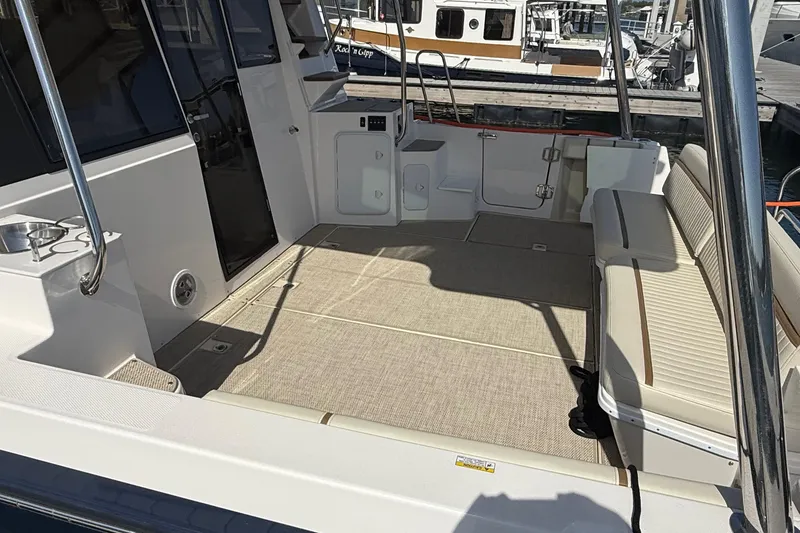 Slide: The Image of Spacious deck of 2026 Ranger Tugs R-43 CB with seating and storage. - 6