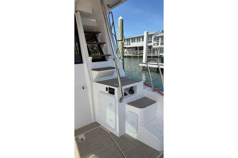 Slide: The Image of Staircase on 2026 Ranger Tugs R-43 CB yacht, docked by the marina. - 8