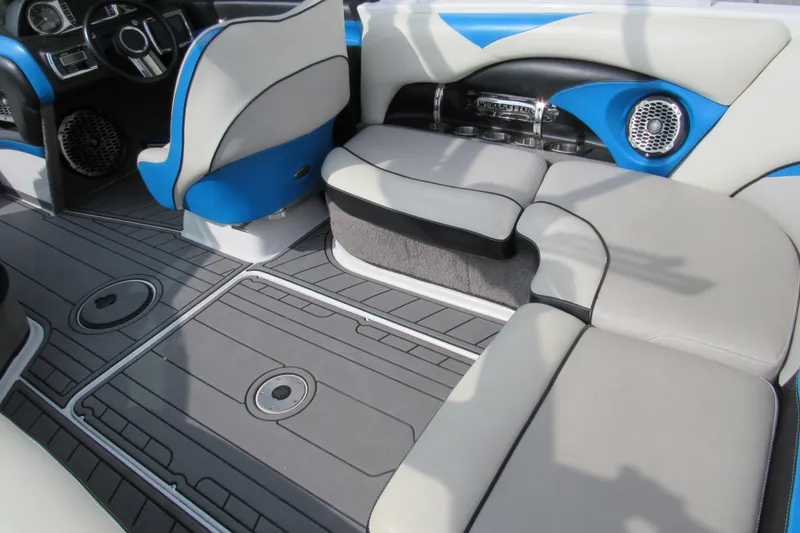 Slide: The Image of 2013 Malibu Wakesetter 20 VTX interior with blue and gray seating and modern dashboard. - 5