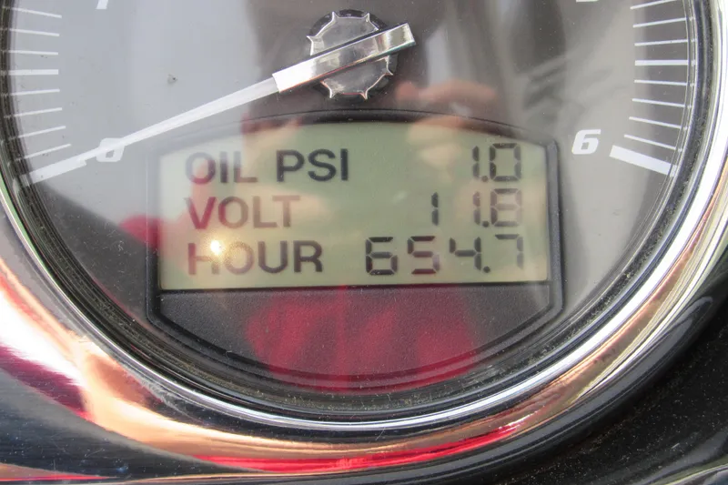 Slide: The Image of Close-up of 2013 Malibu Wakesetter 20 VTX gauge displaying oil PSI, voltage, and hours. - 14