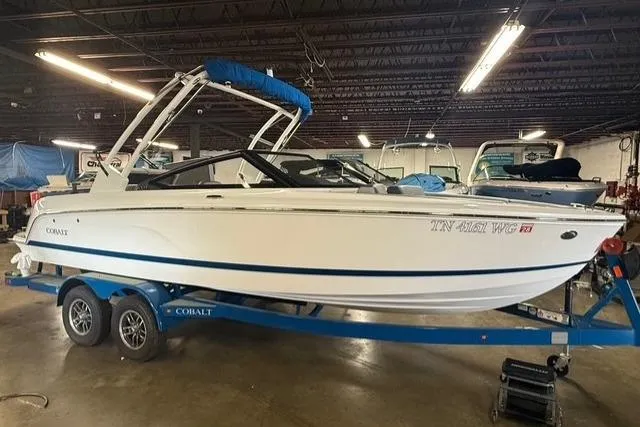 Slide: The Image of 2025 Cobalt CS22 boat on trailer in indoor storage facility. - 1