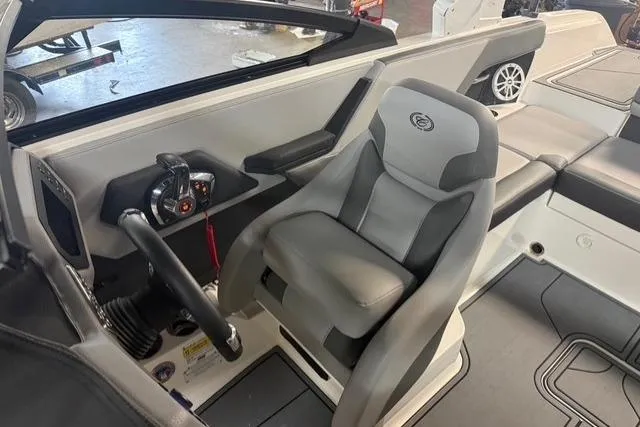 Slide: The Image of 2025 Cobalt CS22 boat interior with gray captain's seat and steering wheel. - 10