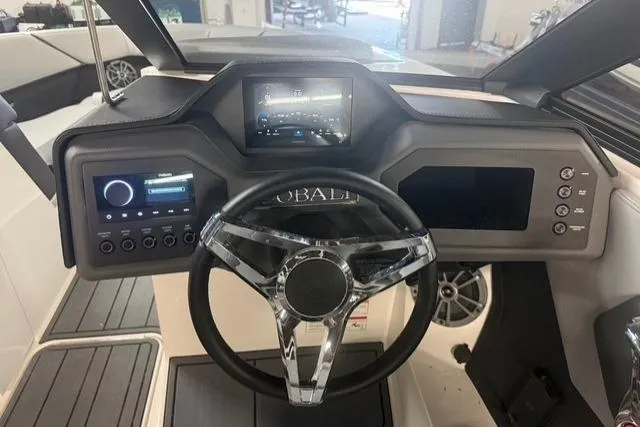 Slide: The Image of 2025 Cobalt CS22 boat dashboard with modern controls and sleek steering wheel design. - 11