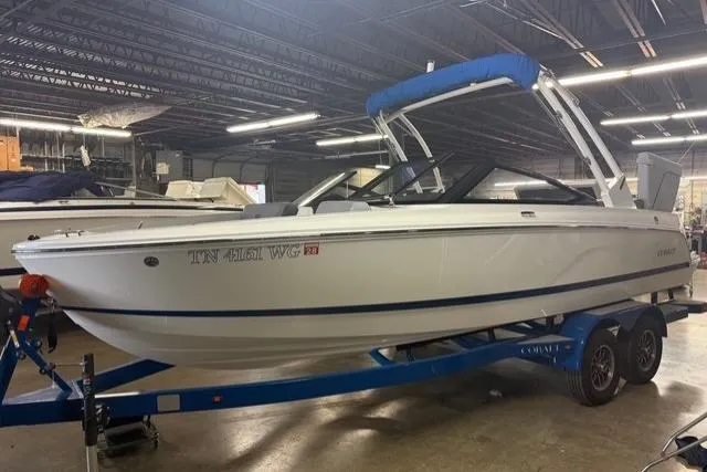 Slide: The Image of 2025 Cobalt CS22 boat on blue trailer in indoor storage facility. - 2
