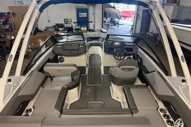 Slide: The Image of 2025 Cobalt CS22 boat interior with gray seating and modern dashboard in a showroom. - 20