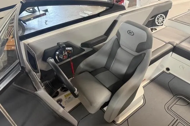 Slide: The Image of 2025 Cobalt CS22 boat interior with steering wheel and gray captain's seat. - 9