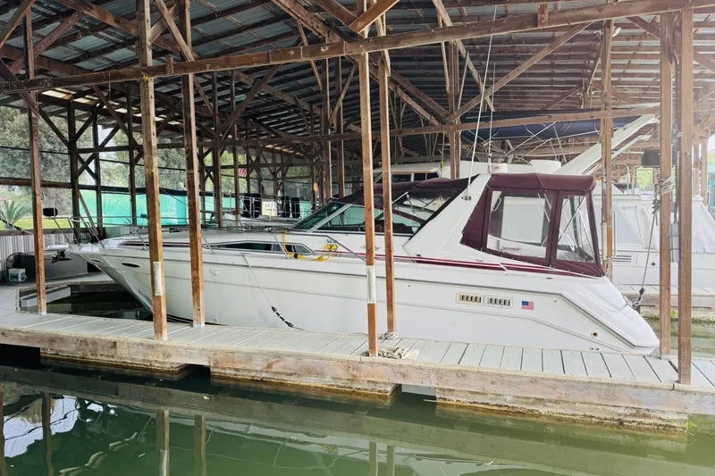 Slide: The Image of 1991 Sea Ray Sundancer 350 docked in a covered marina, side view. - 13