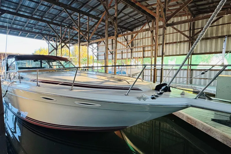Slide: The Image of 1991 Sea Ray Sundancer 350 yacht docked in a covered marina. - 14