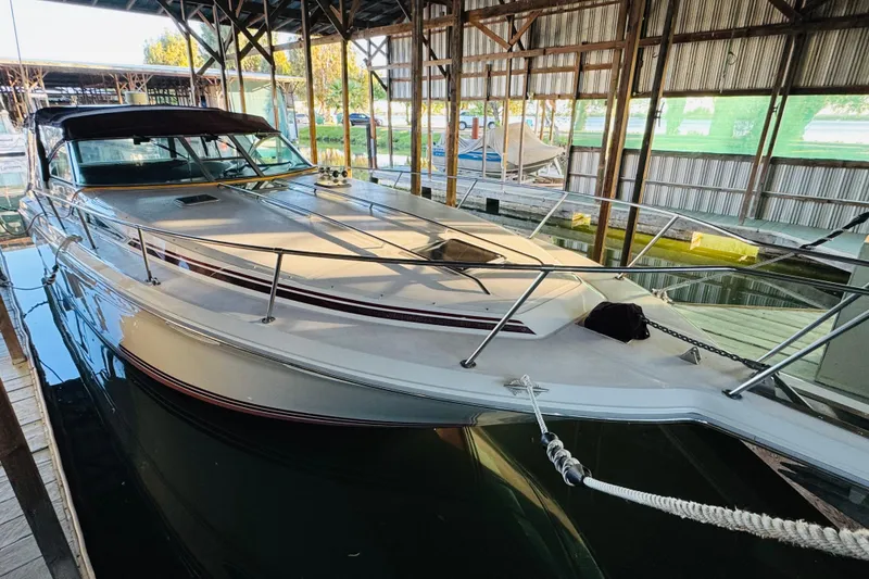 Slide: The Image of 1991 Sea Ray Sundancer 350 docked in a covered marina, showcasing sleek design. - 16