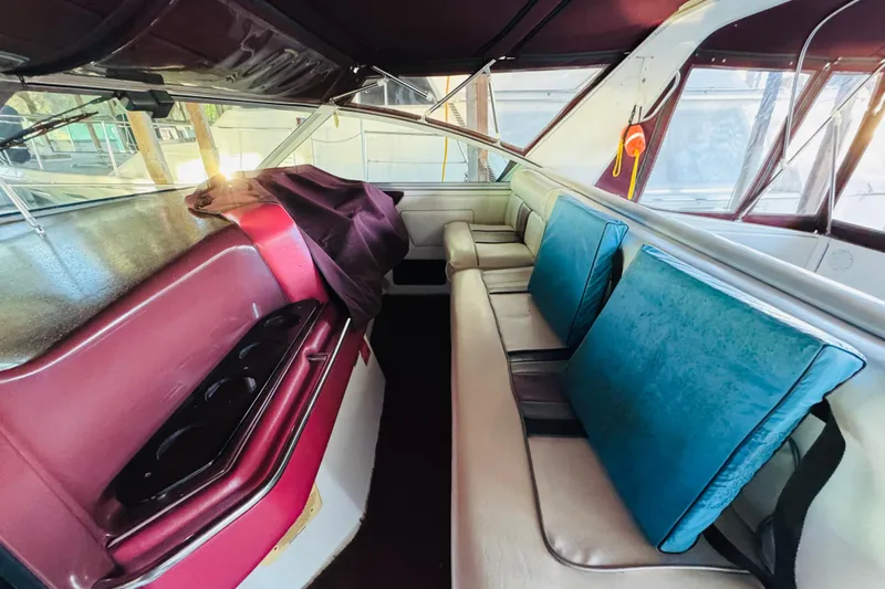 Slide: The Image of Interior of a 1991 Sea Ray Sundancer 350 with maroon and blue seating. - 22