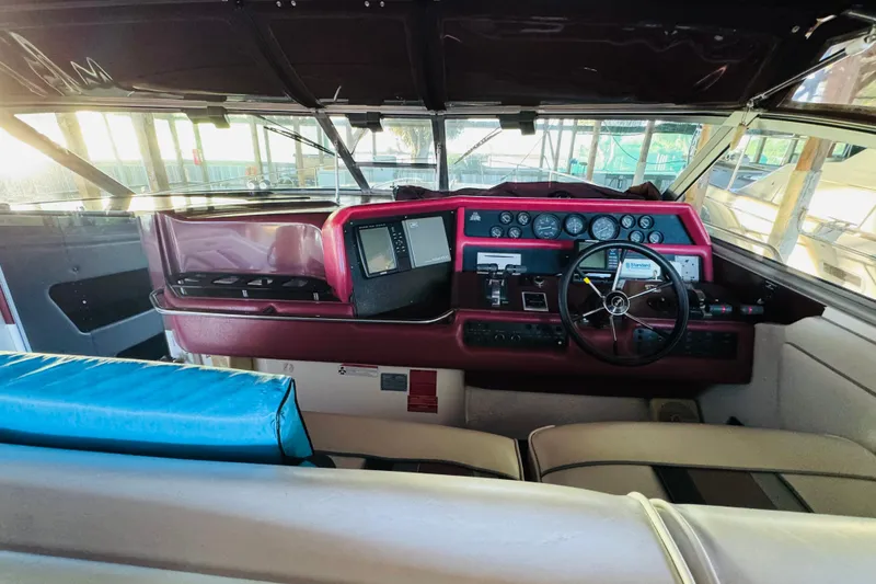 Slide: The Image of 1991 Sea Ray Sundancer 350 helm with steering wheel, gauges, and navigation equipment. - 23