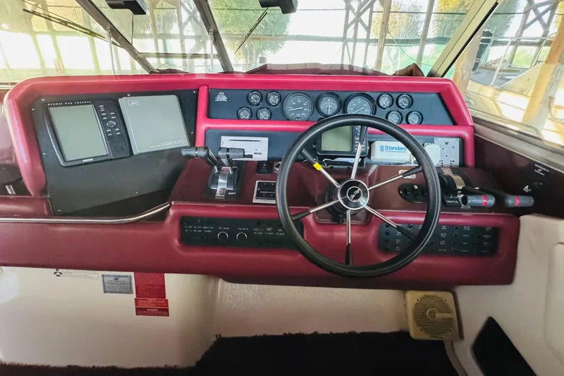 Slide: The Image of Cockpit of 1991 Sea Ray Sundancer 350 with steering wheel and navigation instruments. - 24