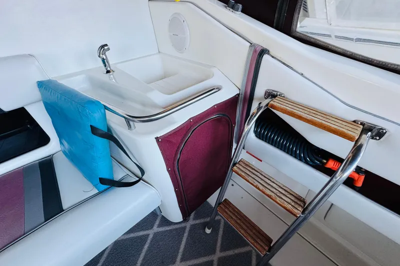 Slide: The Image of Interior of 1991 Sea Ray Sundancer 350 with sink, ladder, and seating area. - 27