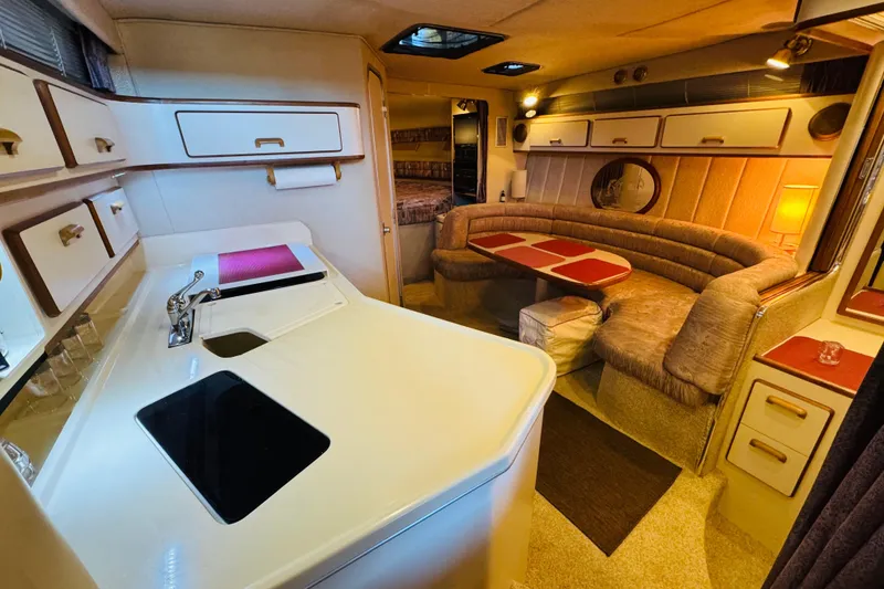 Slide: The Image of Interior of a 1991 Sea Ray Sundancer 350 yacht with kitchen and seating area. - 28
