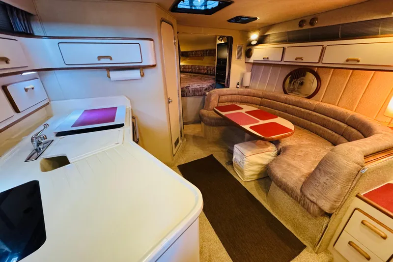 Slide: The Image of Interior of 1991 Sea Ray Sundancer 350 yacht with cozy seating and kitchenette. - 29