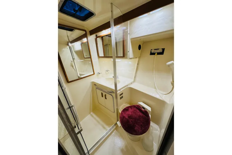Slide: The Image of Bathroom interior of 1991 Sea Ray Sundancer 350 yacht, featuring sink, toilet, and shower. - 38