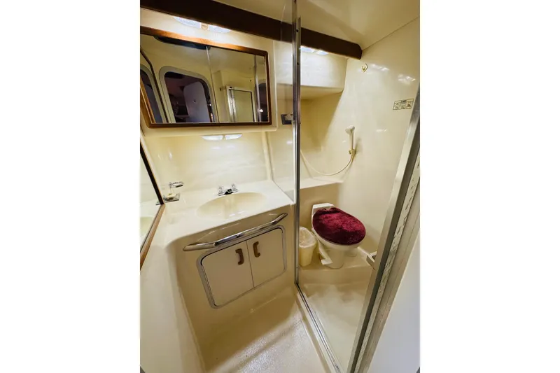 Slide: The Image of Bathroom interior of 1991 Sea Ray Sundancer 350 yacht, featuring sink, mirror, and toilet. - 39