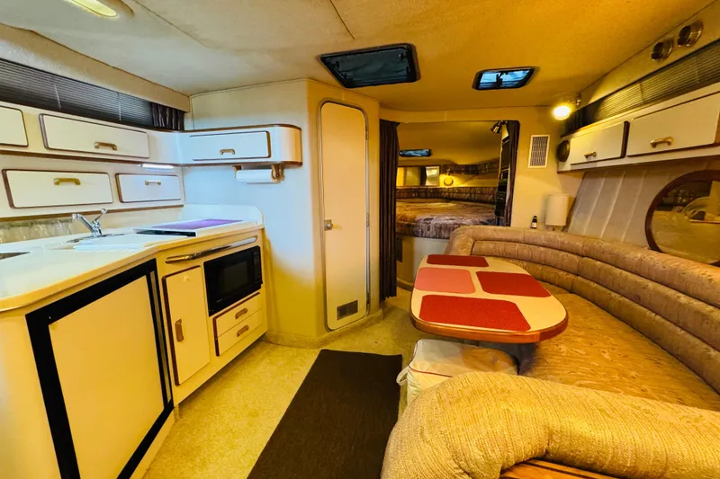 Slide: The Image of Interior of 1991 Sea Ray Sundancer 350 yacht with kitchen and seating area. - 40