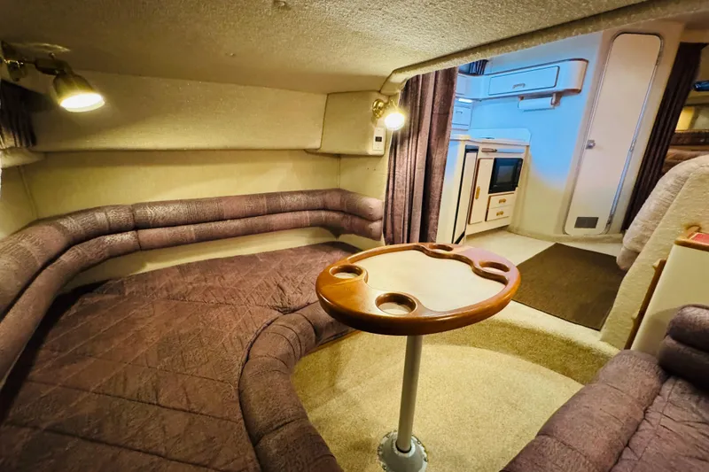Slide: The Image of 1991 Sea Ray Sundancer 350 cabin interior with cozy seating and wooden table. - 41