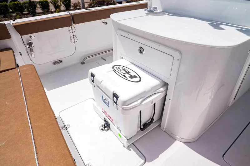 Slide: The Image of Interior of Sea Hunt ULTRA 285CB 2026 with cooler and seating area. - 12