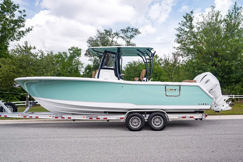 Slide: The Image of 2026 Sea Hunt ULTRA 285CB boat on trailer, side view. - 2