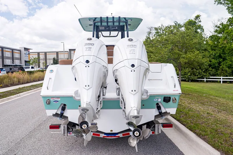 Slide: The Image of Rear view of Sea Hunt ULTRA 285CB boat, 2026 model, featuring twin outboard engines. - 4