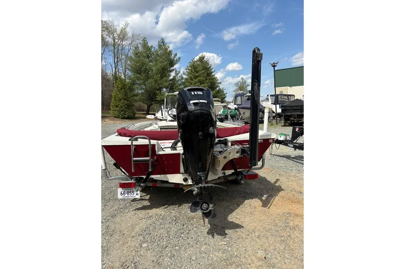 Slide: The Image of 2016 Ranger RB190 boat with outboard motor, parked outdoors under a blue sky. - 3