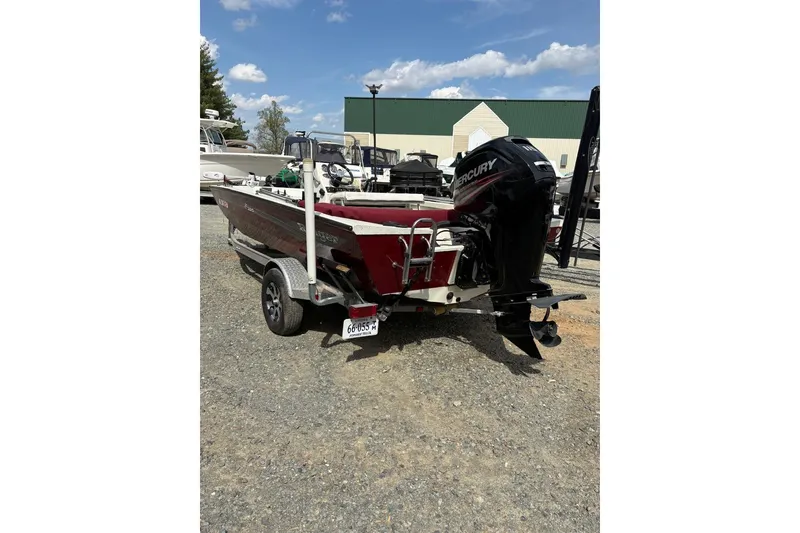 Slide: The Image of 2016 Ranger RB190 boat with Mercury engine on trailer, parked outdoors. - 4
