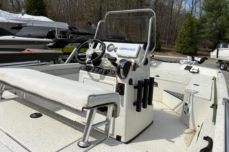 Slide: The Image of 2016 Ranger RB190 boat interior with steering console and seating, docked outdoors. - 9