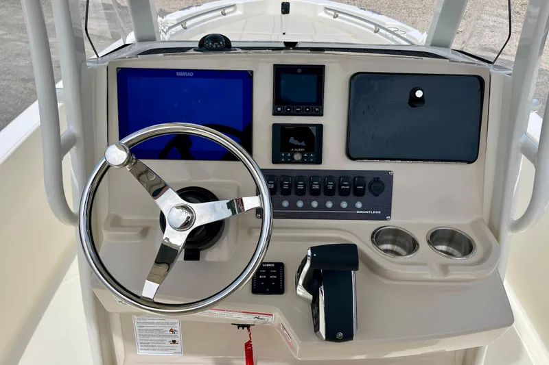 Slide: The Image of Boston Whaler 220 Dauntless 2026 helm with steering wheel and controls. - 14