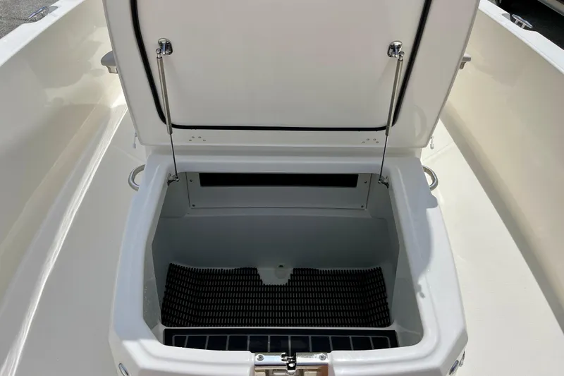 Slide: The Image of Boston Whaler 220 Dauntless 2026 storage compartment with open lid. - 23