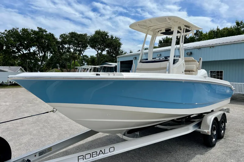 Slide: The Image of 2026 Boston Whaler 220 Dauntless boat on trailer, blue hull. - 4