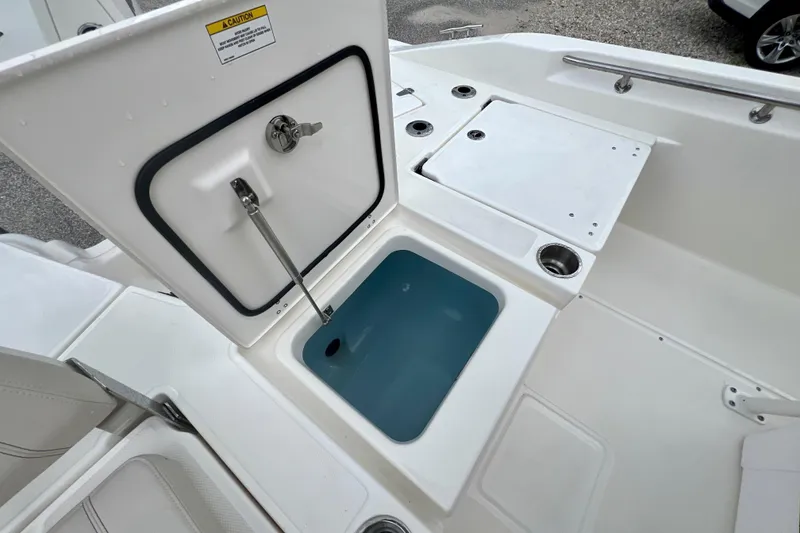Slide: The Image of Boston Whaler 250 Dauntless 2026 with open storage compartment. - 12