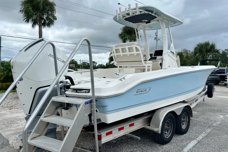 Slide: The Image of 2026 Boston Whaler 250 Dauntless on trailer, blue hull, outboard motor. - 8