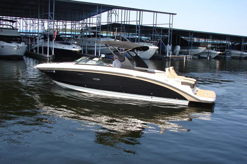 Slide: The Image of 2018 Sea Ray SDX 290 boat seat with beige upholstery and fishing rod. - 16