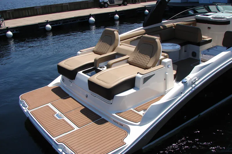 Slide: The Image of 2018 Sea Ray SDX 290 boat with luxurious seating and teak deck by the water. - 3