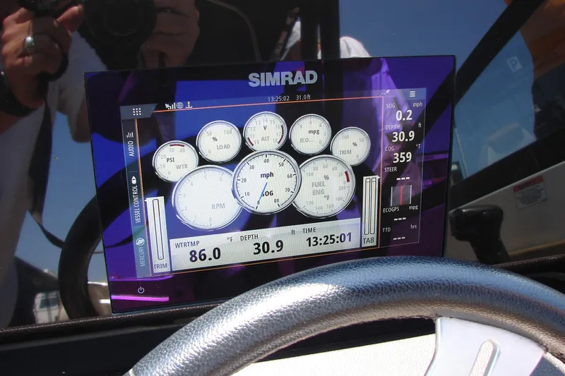 Slide: The Image of 2018 Sea Ray SDX 290 boat interior with seating and built-in mini fridge. - 30