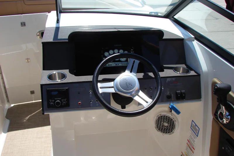 Slide: The Image of 2018 Sea Ray SDX 290 boat interior with beige seating and speaker detail. - 33