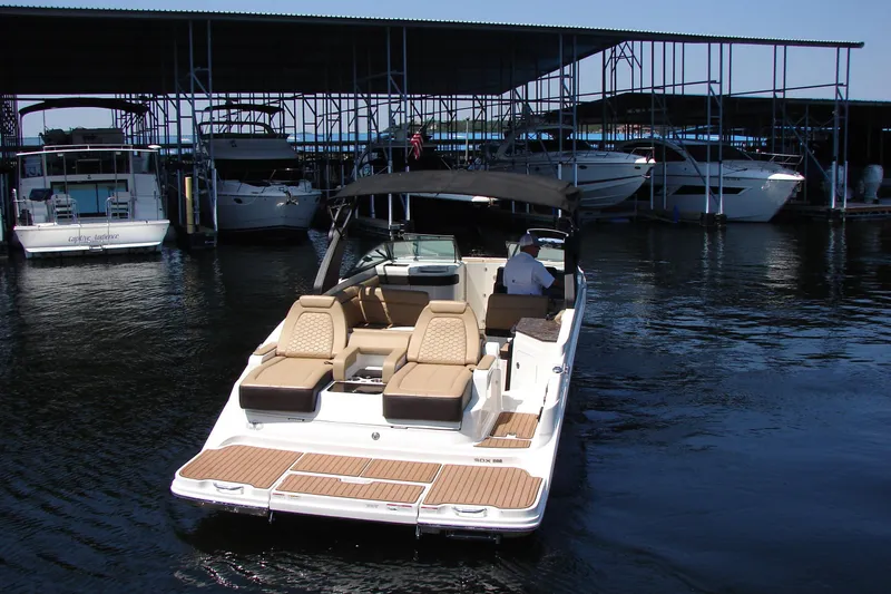 Slide: The Image of 2018 Sea Ray SDX 290 boat docked at marina with covered slips. - 8