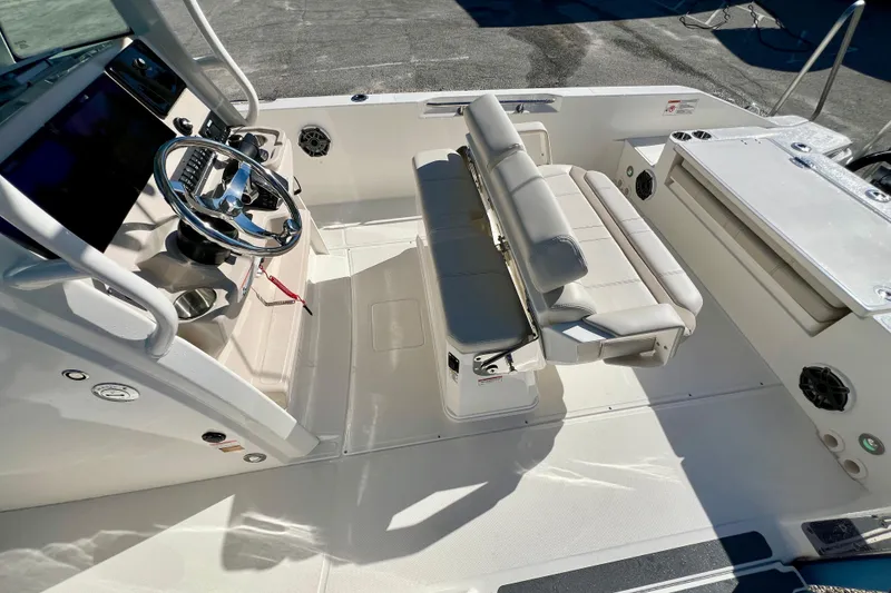 Slide: The Image of Interior of 2026 Boston Whaler 280 Dauntless with helm and seating area. - 17