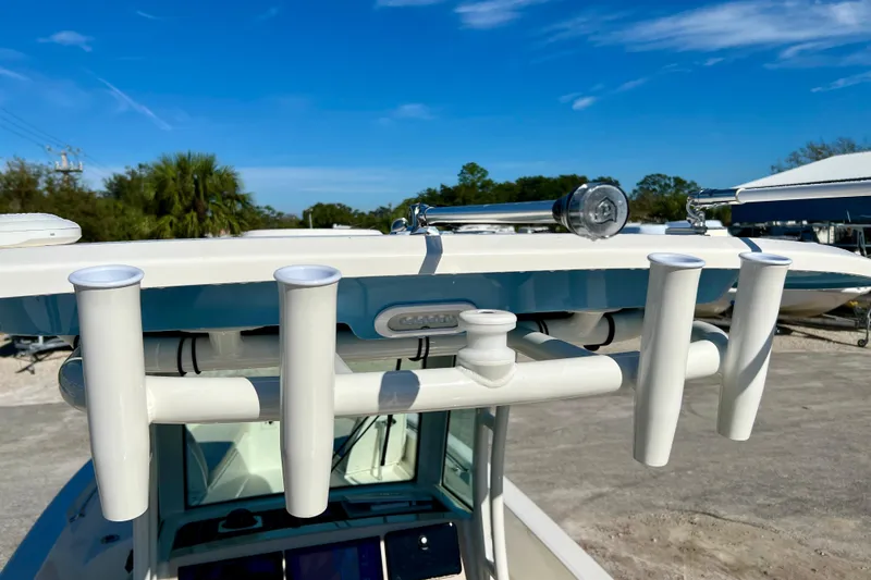 Slide: The Image of Boston Whaler 280 Dauntless 2026 with rod holders and blue sky. - 35