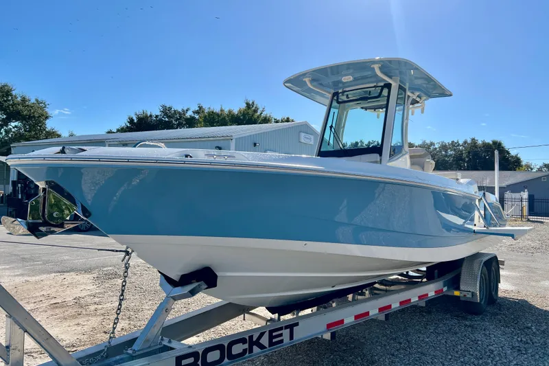 Slide: The Image of 2026 Boston Whaler 280 Dauntless on trailer, blue hull, sunny day. - 4