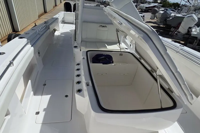 Slide: The Image of 2020 Invincible 35 Catamaran with open storage compartment, sleek white deck design. - 11