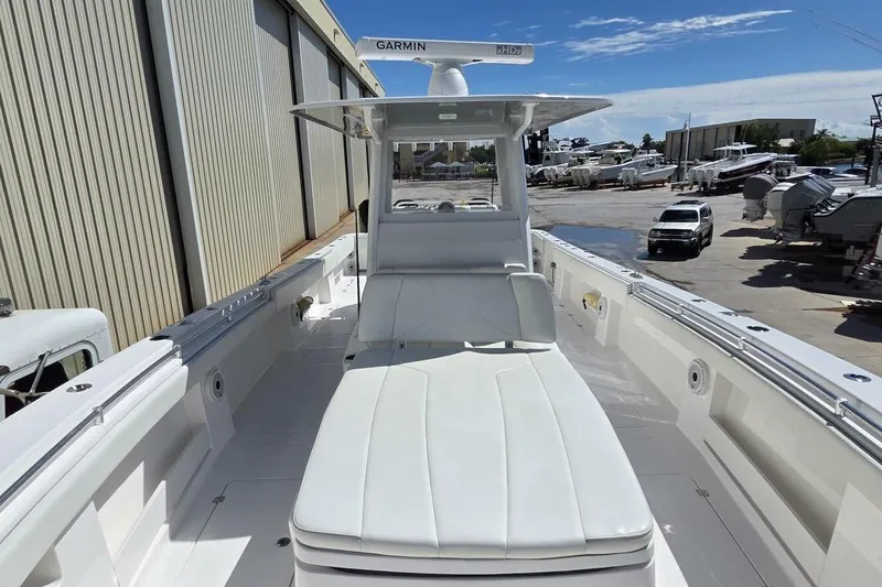 Slide: The Image of 2020 Invincible 35 Catamaran with sleek white deck and Garmin radar, docked at marina. - 2