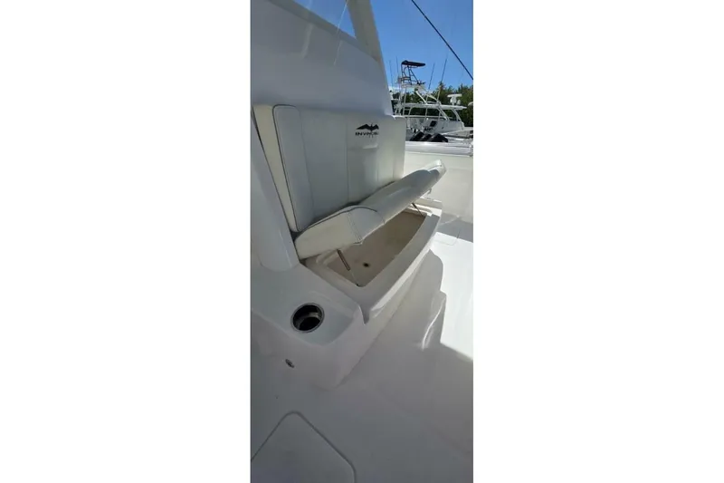 Slide: The Image of 2020 Invincible 35 Catamaran interior with white seating and storage compartment. - 21